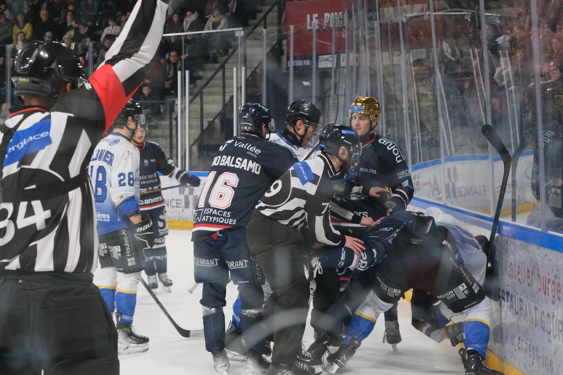 Cédric Di Dio Balsamo tentant d'écarter les joueurs des Rapaces de Gap alors que Sami Tavernier et Janis Zemitis se battent dans un match de Ligue Magnus entre Angers et Gap