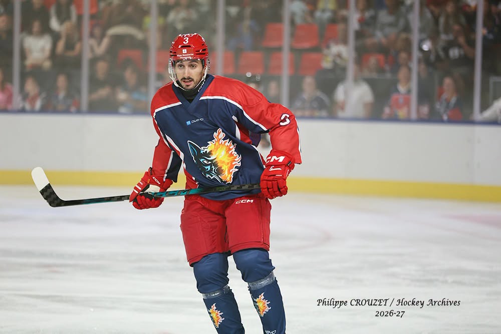 Joueur de hockey sur glace en uniforme rouge et bleu