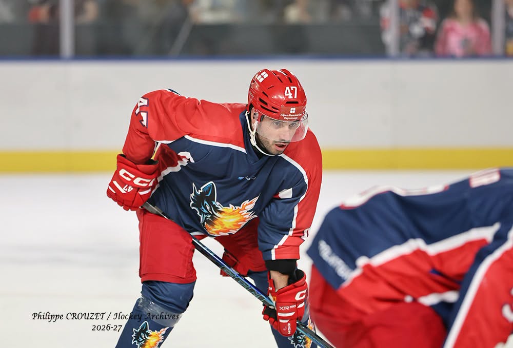 Hockeyeur en tenue rouge et bleue sur la glace